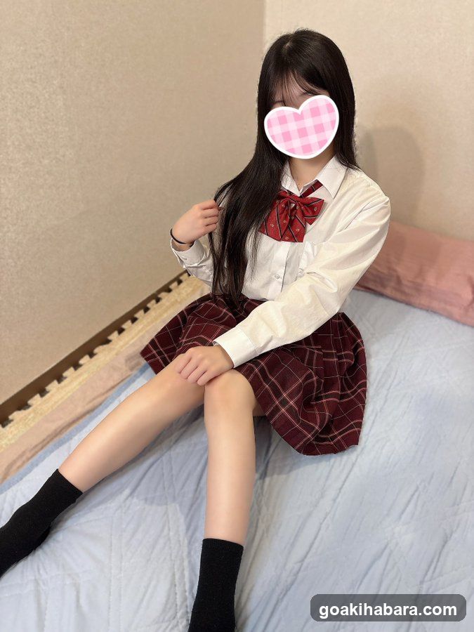 School uniform girl sitting on bed