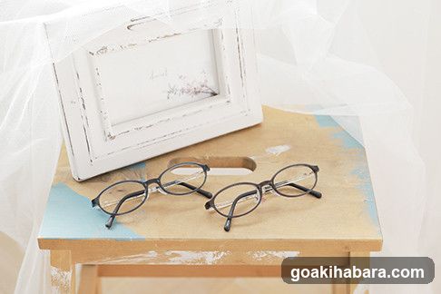 Glasses on a wooden surface with a frame