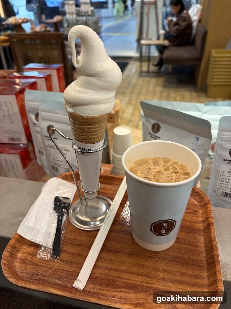 Soft-serve ice cream and iced coffee on a wooden tray