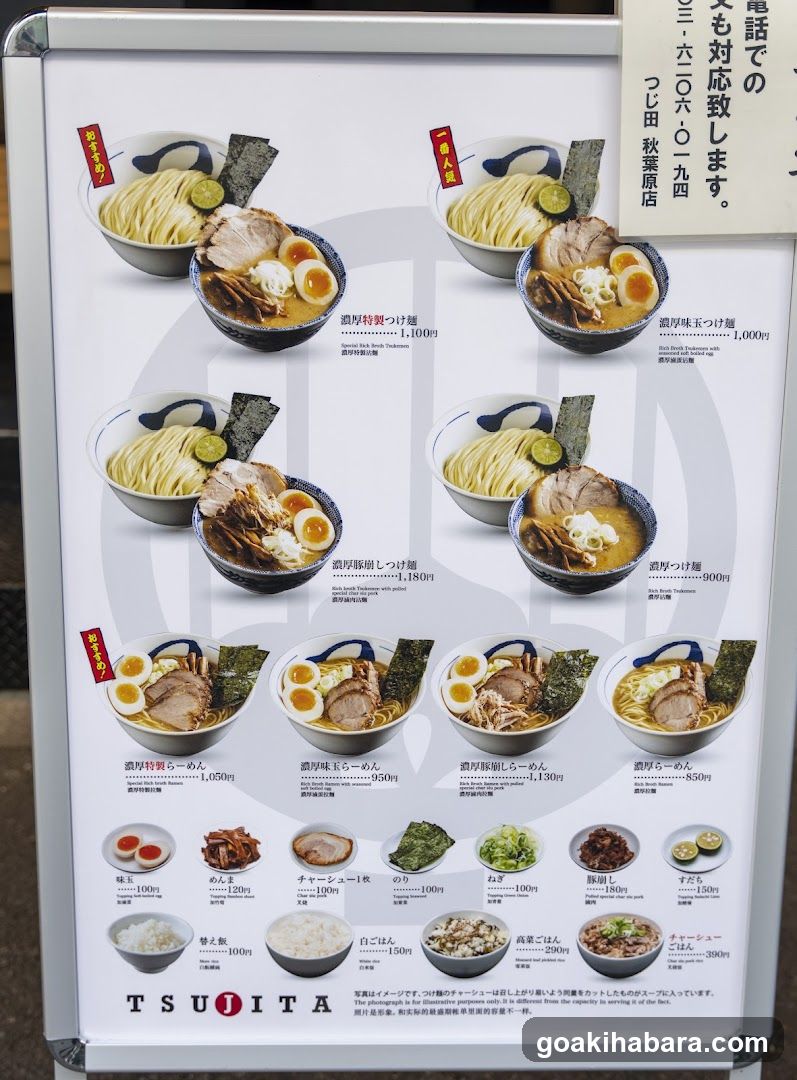 A printed menu board displaying various ramen dishes with photos, names, prices, and side items.