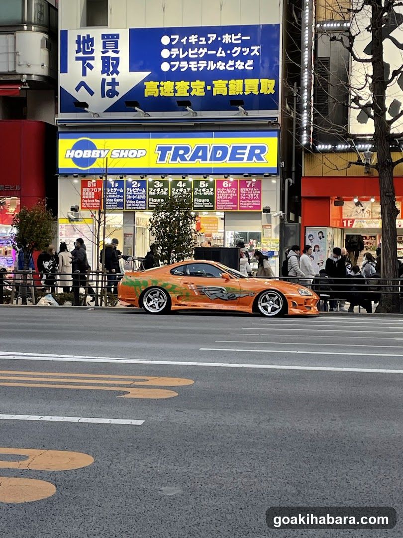 Street Scene with Orange Car and Storefronts