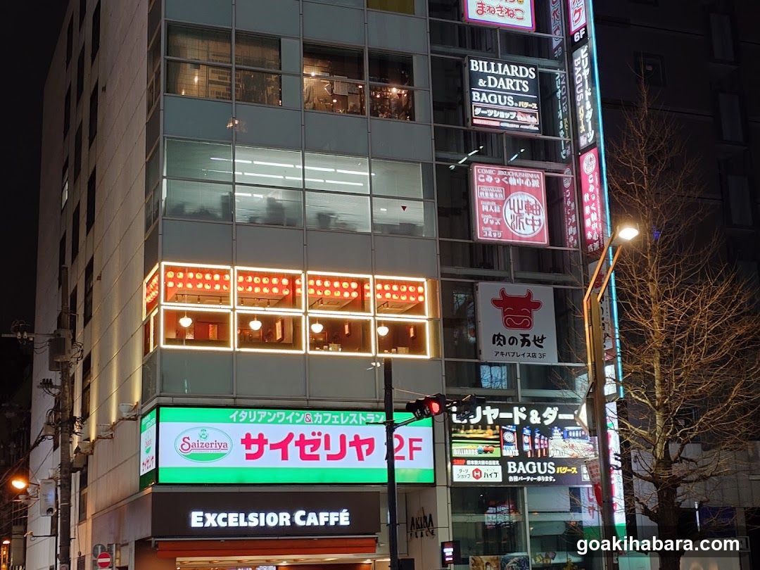 Night street scene with illuminated building facade