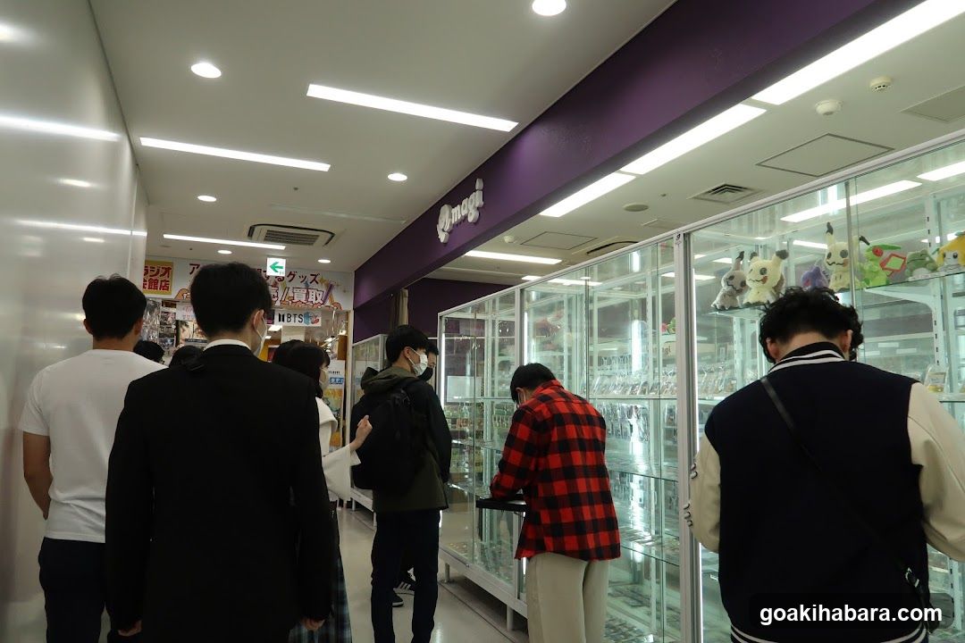 Interior of a store with customers browsing glass display cases