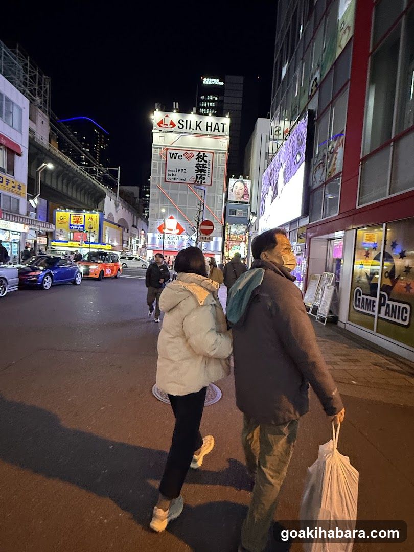 Night street scene with pedestrians and illuminated storefronts