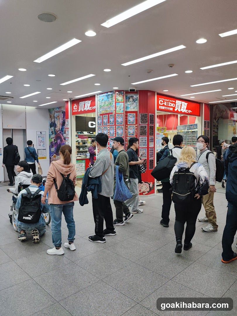 Crowded indoor space with shop in background