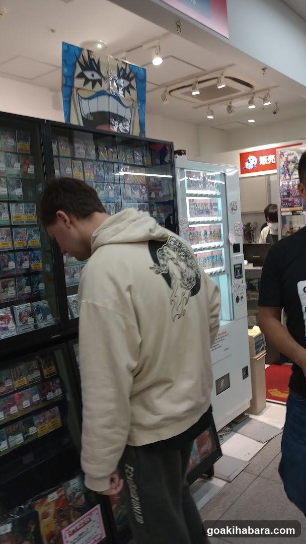 Person browsing in a store with vending machines and posters