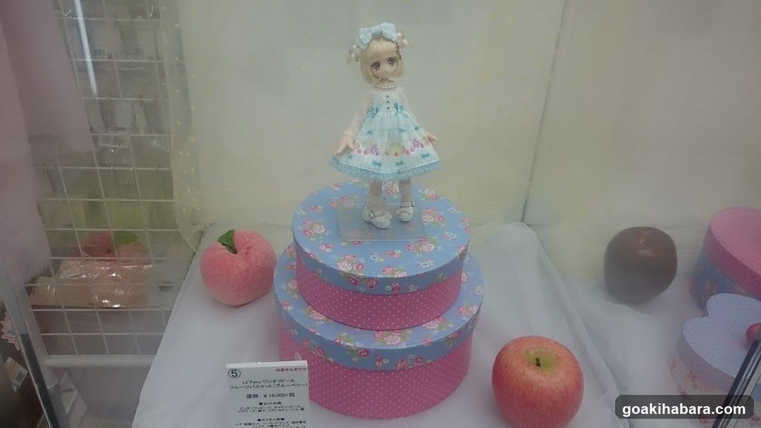 Doll Display with Apples and Boxes