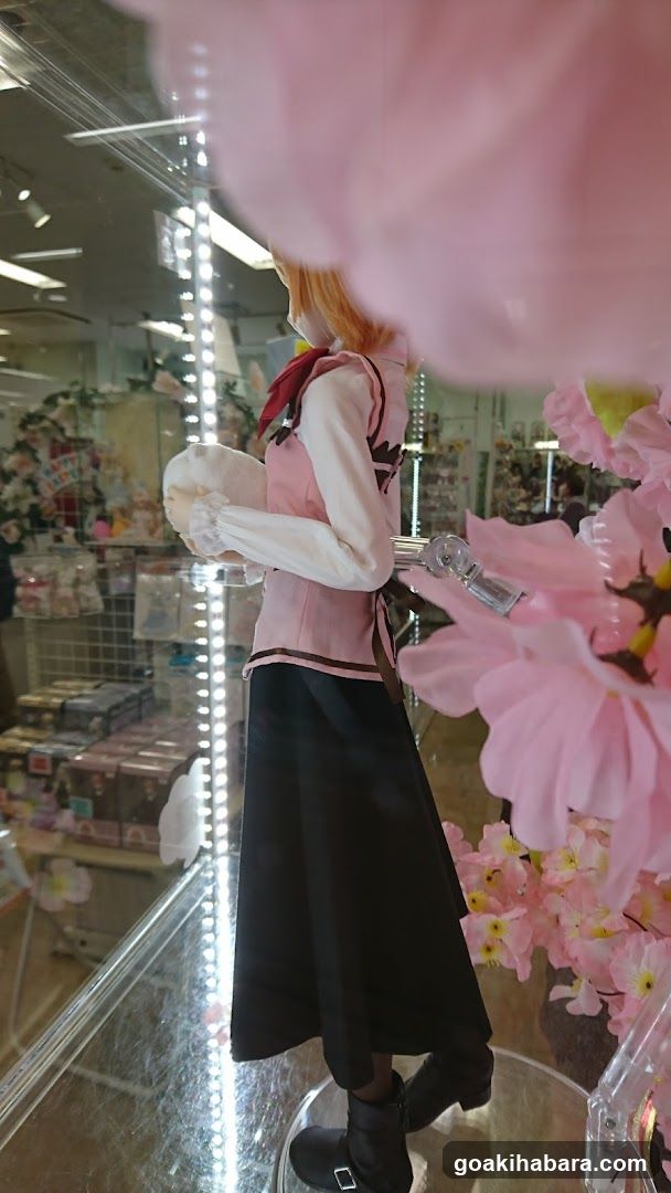 Anime-style figure display in store window