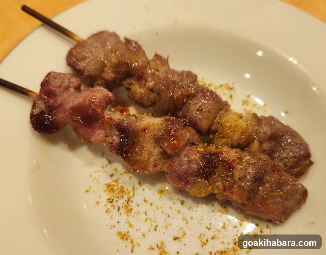Grilled Meat Skewers on a White Plate