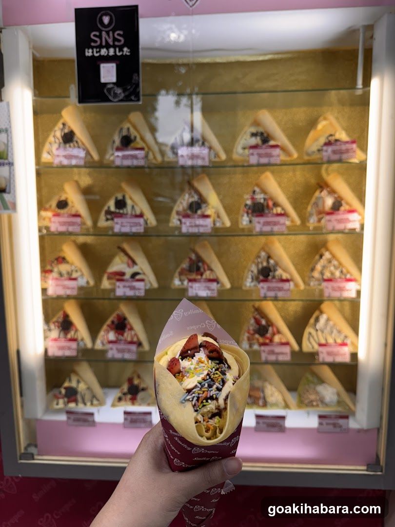 Hand holding crepe in front of display case