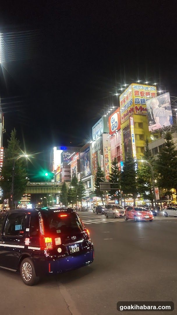 Night street scene with illuminated buildings and vehicles