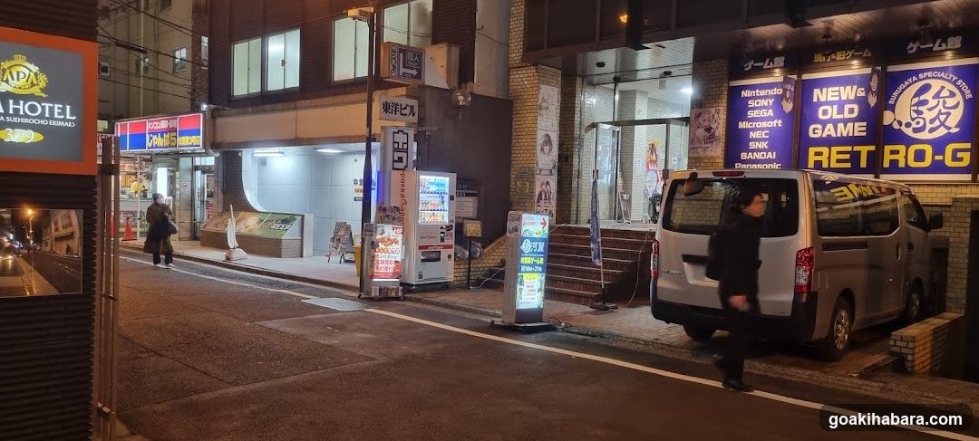 Night street scene with shops and vending machines