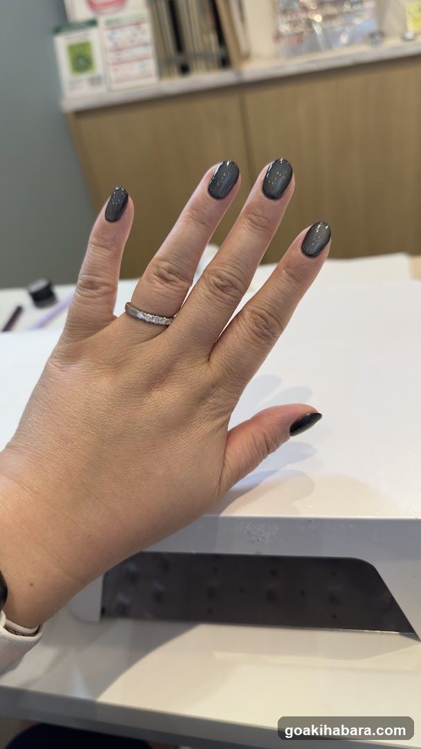 Hand with Dark Grey Nail Polish and Ring