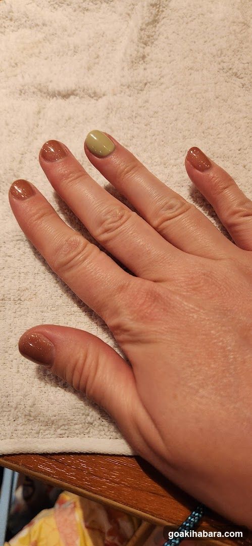 Hand with Nail Polish on Towel