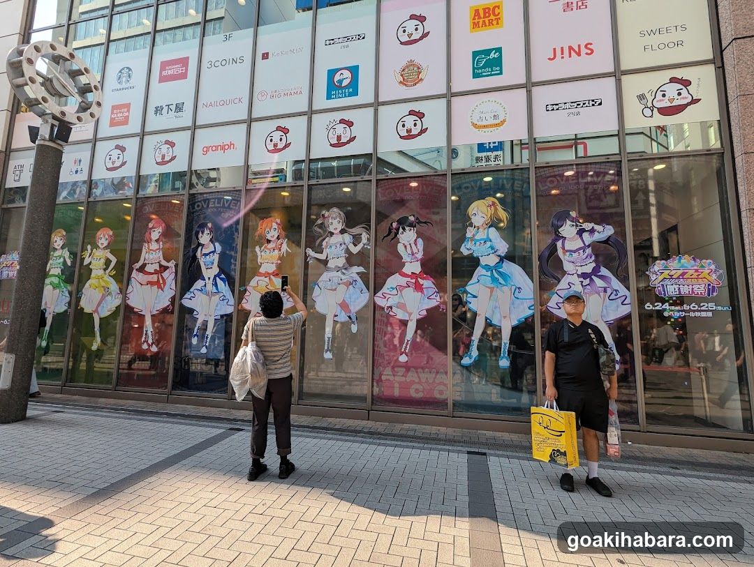 Anime-themed storefront with character posters and shop signs