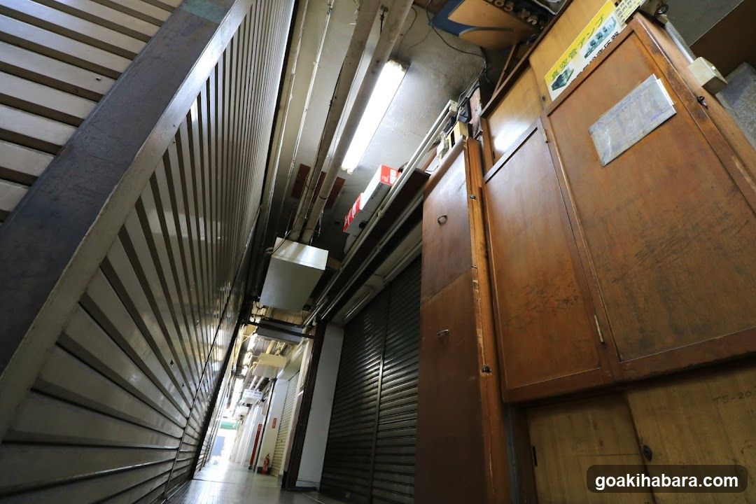 Narrow Alleyway with Closed Shutters and Wooden Cabinets