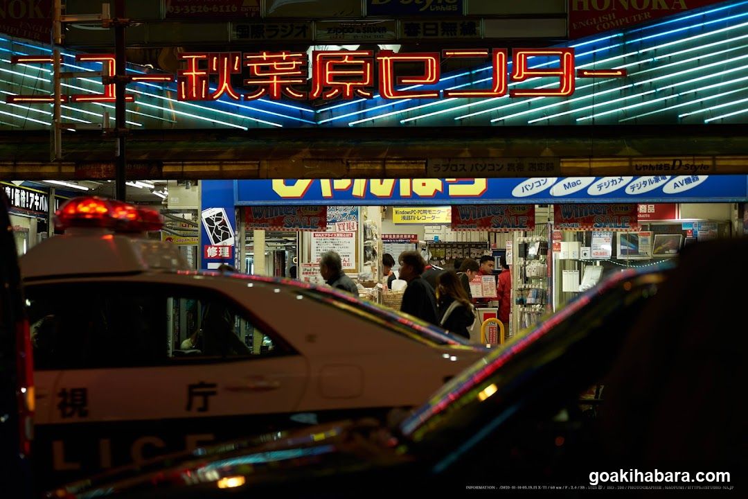 Night Street Scene with Police Car and Storefronts