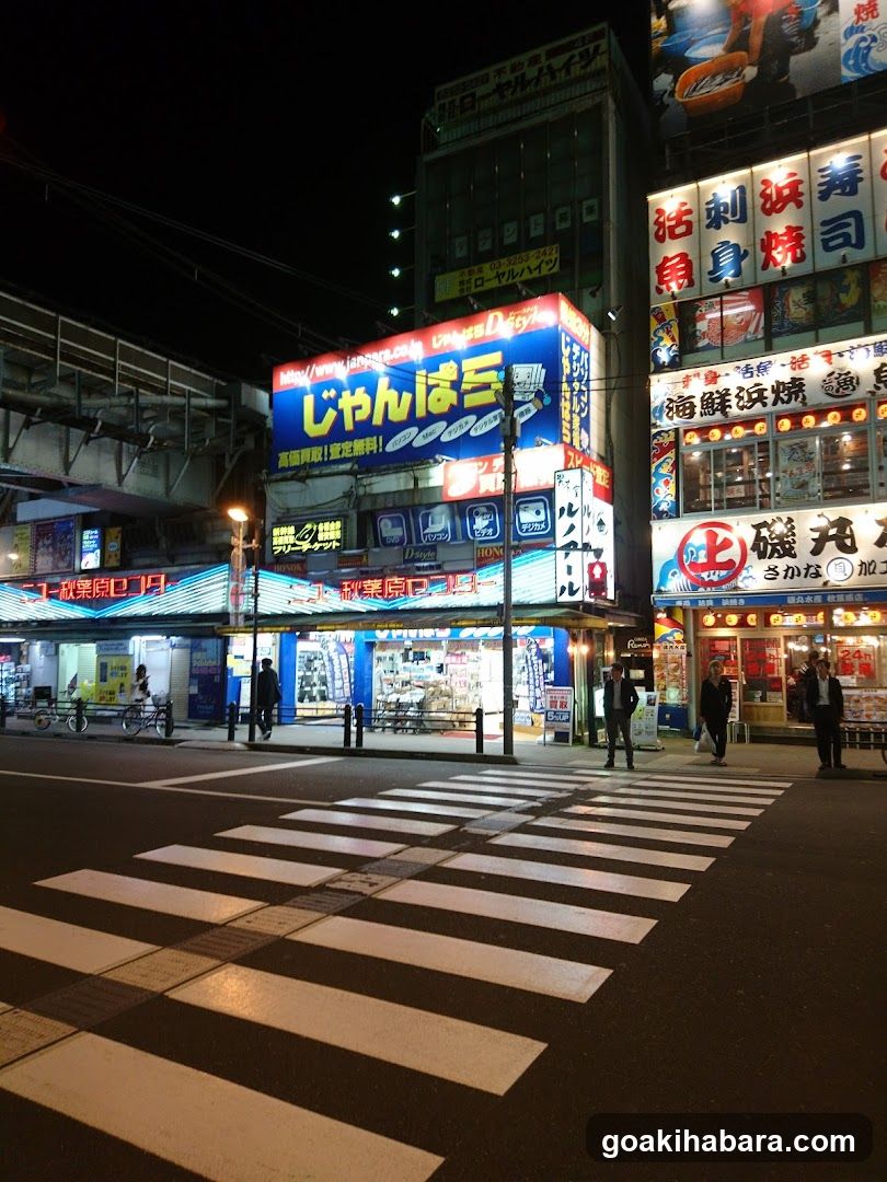Night street scene with illuminated signs and storefronts