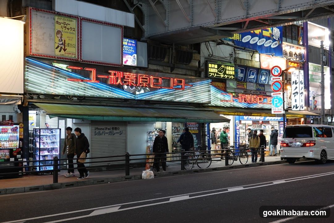 Night street scene with illuminated storefronts