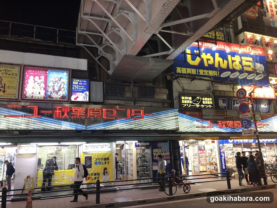 Night street scene with illuminated storefronts