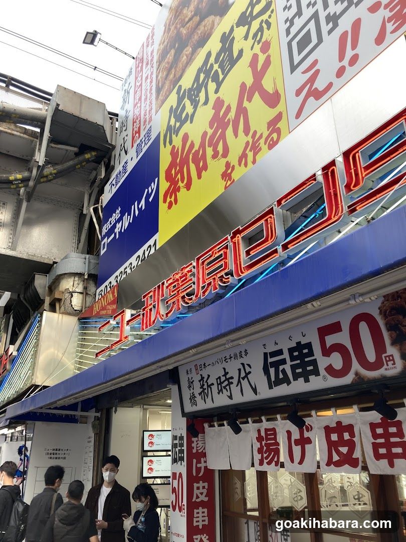Street-side food stall with signage and customers