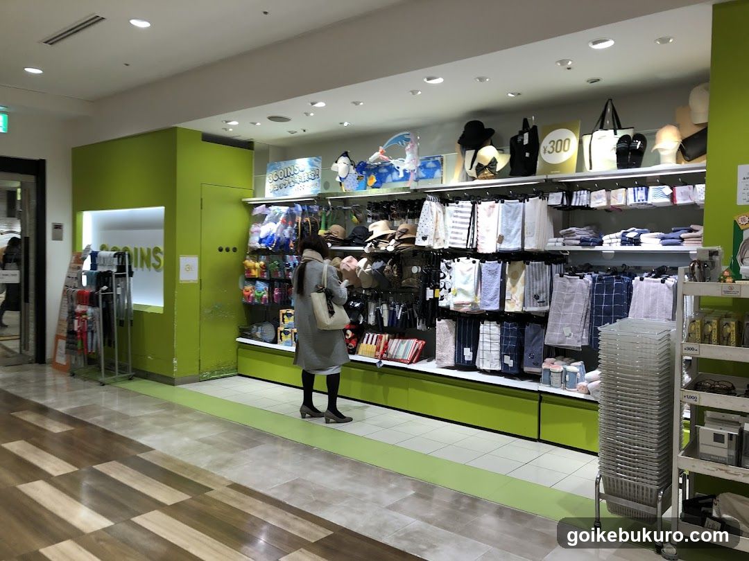 Interior of a retail store with green walls and shelves displaying various products.