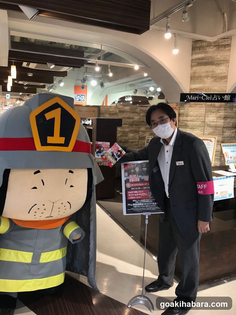 Staff with mascot and poster