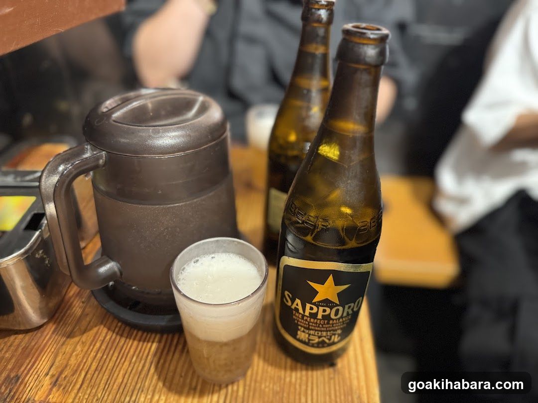 Sapporo Beer and Mug on Wooden Table
