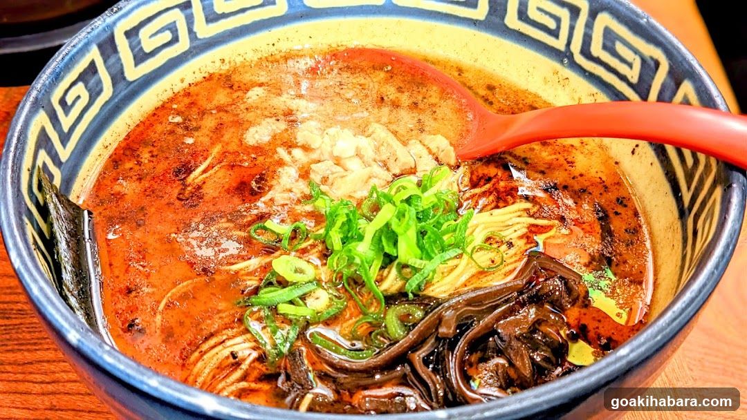 Bowl of Ramen with Green Onions and Red Broth
