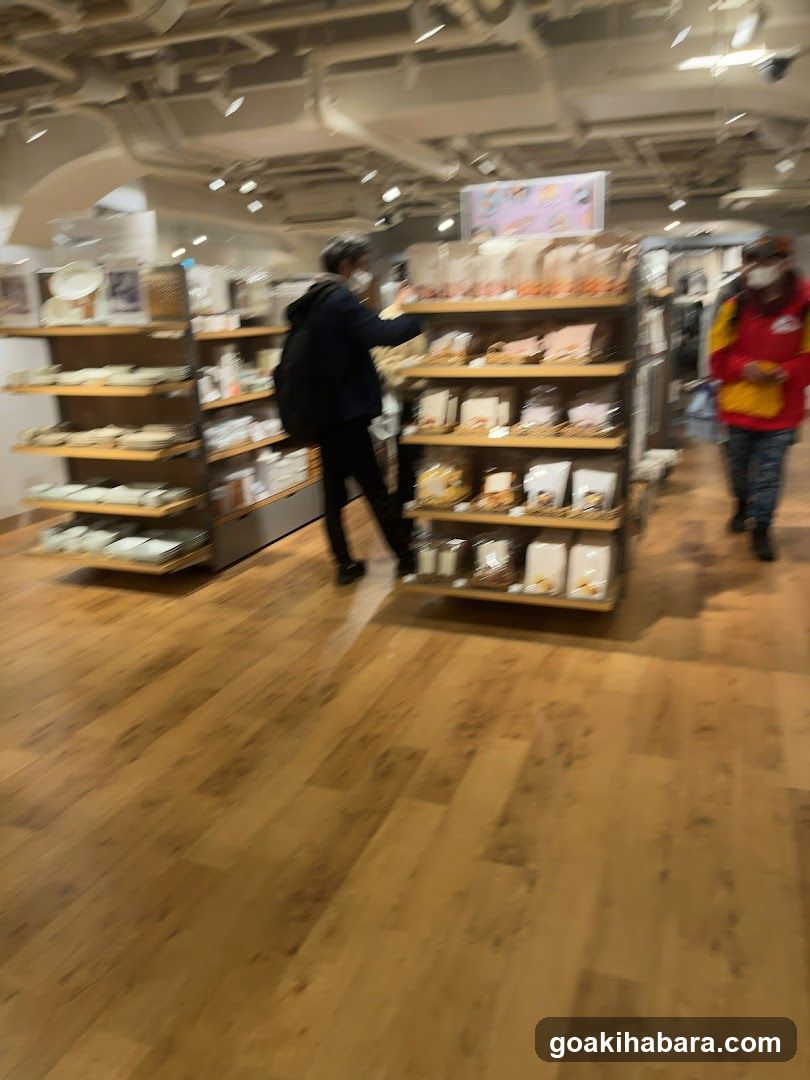 Interior of a retail store with wooden flooring and shelving units displaying various packaged goods.