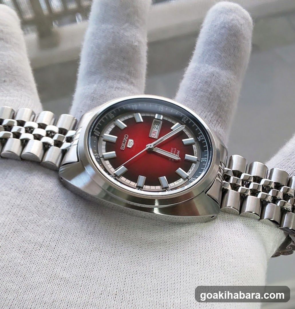Seiko Red Dial Watch on Gloved Hand