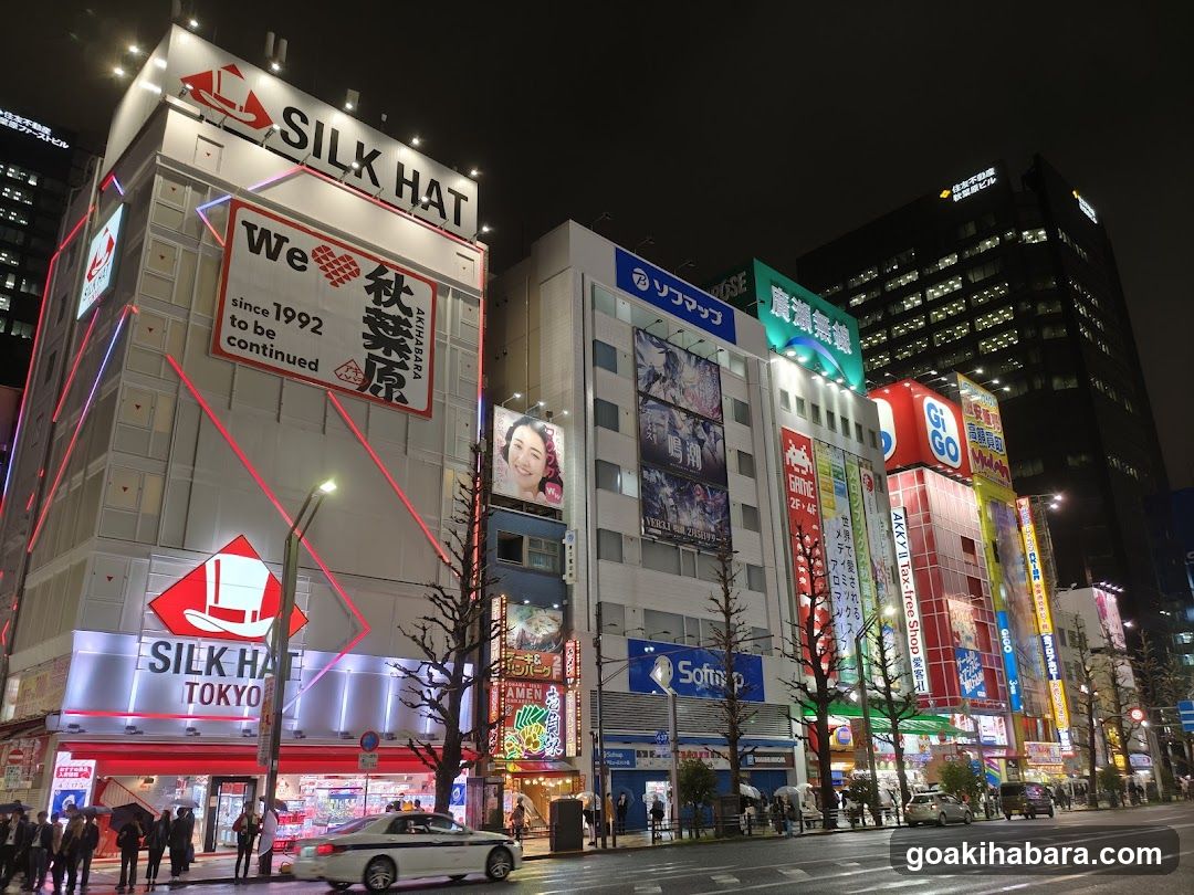 Night street scene with illuminated buildings and signage