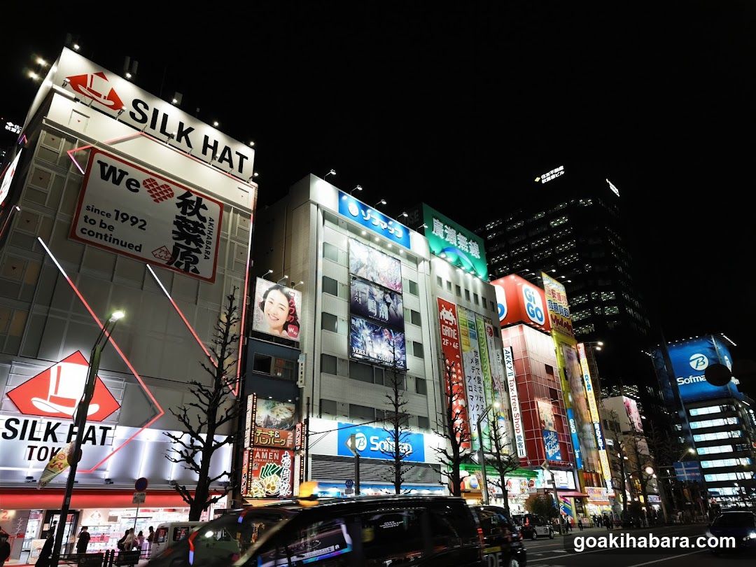 Night street scene with illuminated buildings and signs