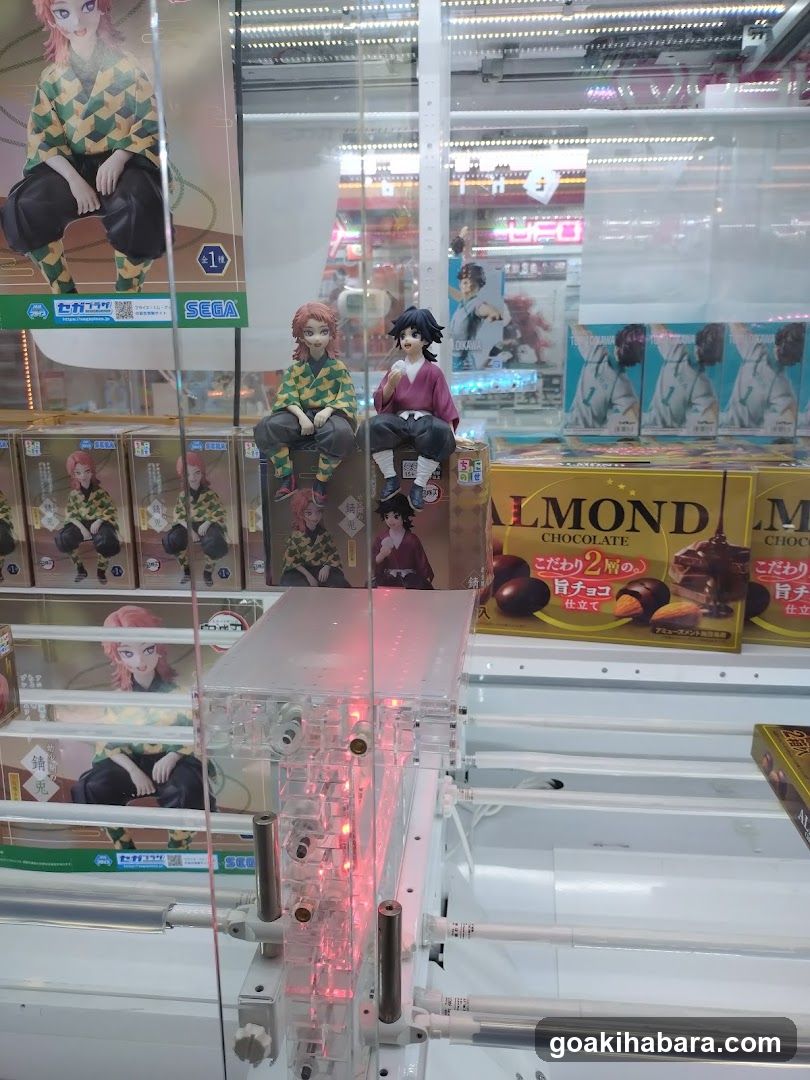 Claw Machine Display with Anime Merchandise and Almond Chocolate Boxes
