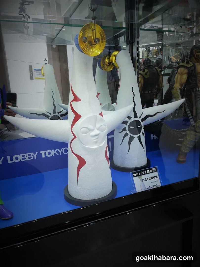 Exhibition Display of White Sculptures with Sun and Moon Motifs