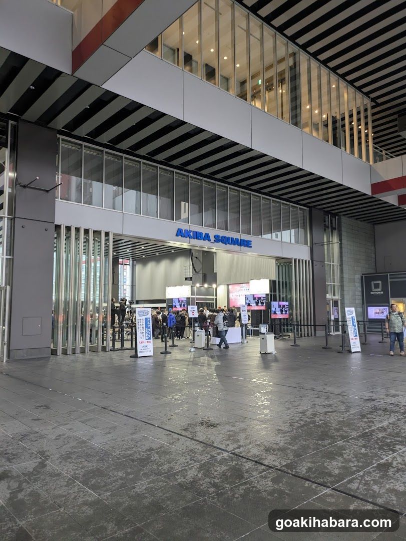 Exterior view of Akiba Square entrance with visible signage and people gathered near the entrance.