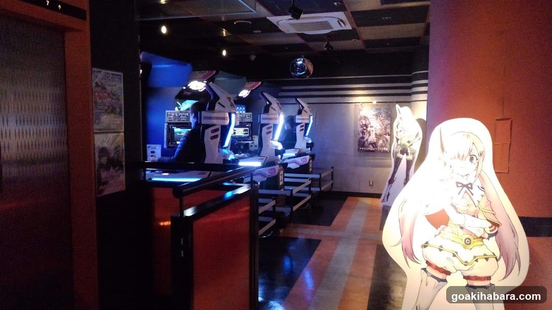 Anime-themed arcade interior with cutout figures and gaming machines