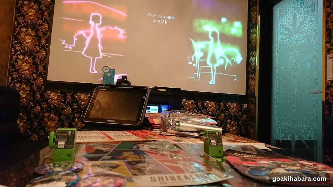Karaoke Room Interior with Anime Merchandise