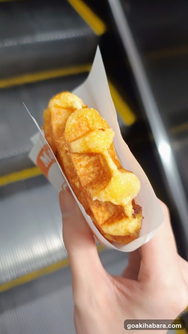 Hand holding a waffle cone with banana slices