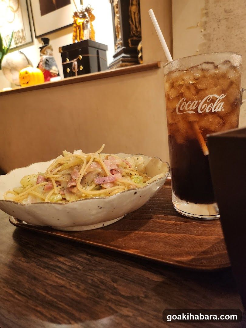Pasta and Coca-Cola at a cafe table