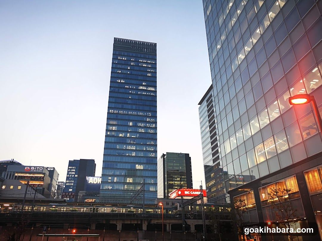 Cityscape with tall buildings and illuminated storefronts