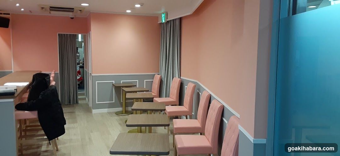 Interior of a pink-themed room with tables and chairs