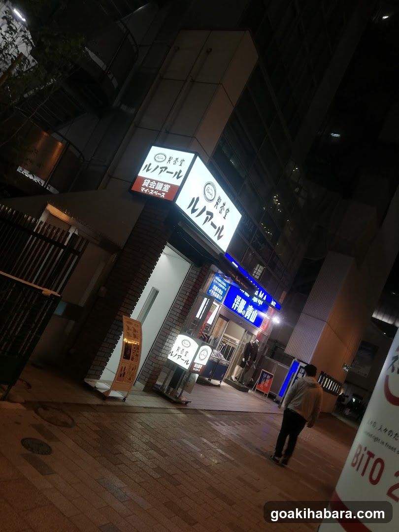 Night street scene with illuminated storefronts