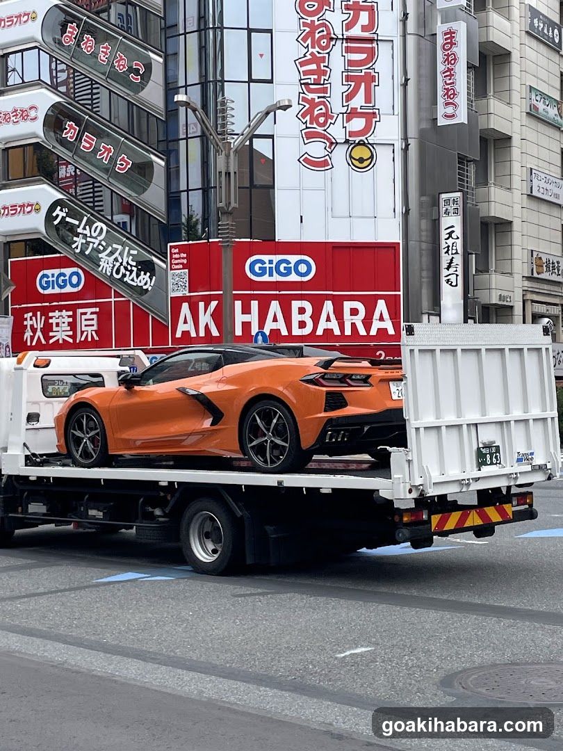 Orange sports car on flatbed truck in Japan