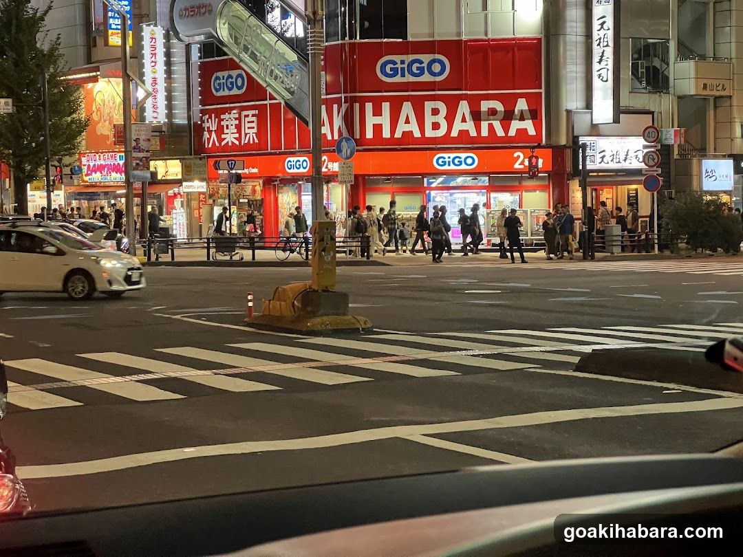 Night street scene with shops and pedestrians