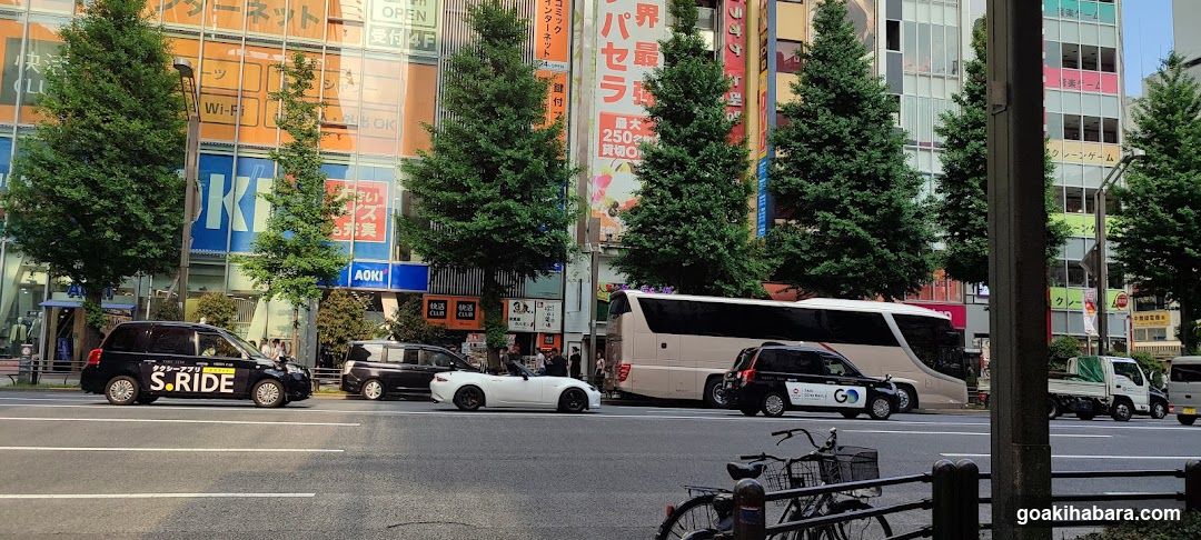 Busy Street Scene with Vehicles and Buildings