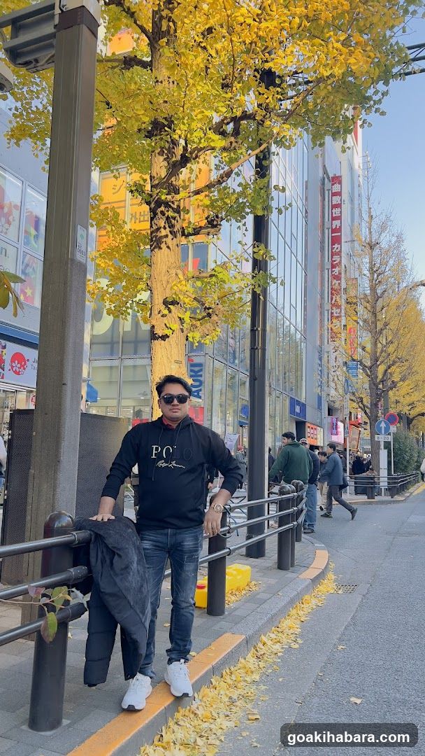 Man standing on sidewalk in autumn