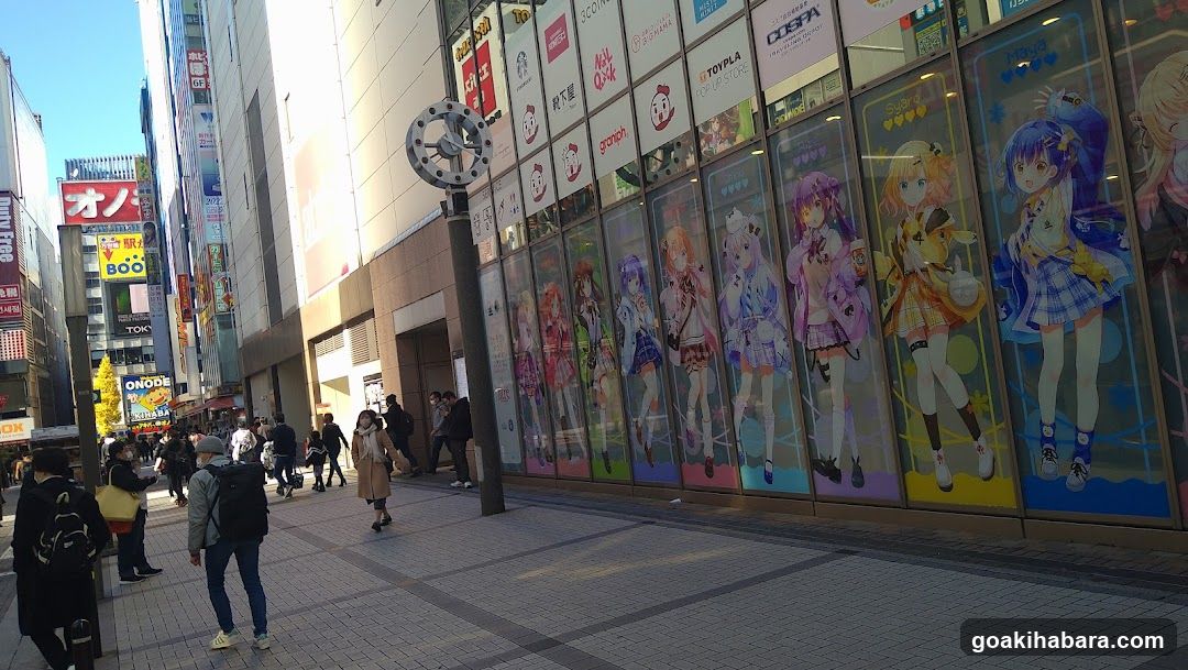 Anime-themed storefront display in urban street scene