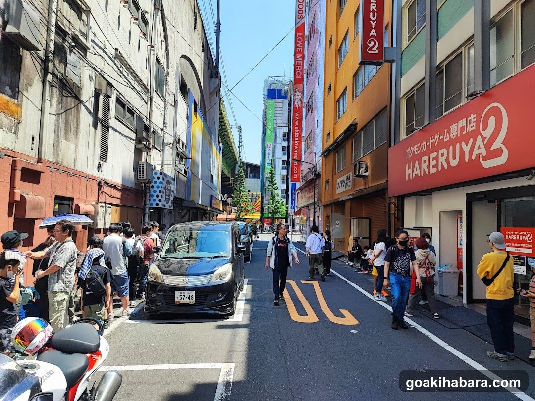 Crowded Street with Shops and Vehicles