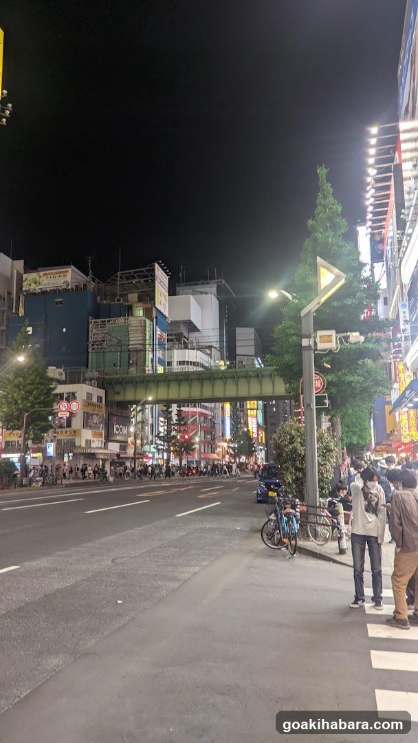 Night street scene with pedestrians and bicycles